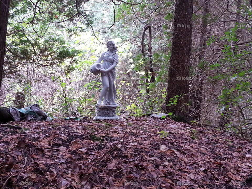 lady statue in the woods 