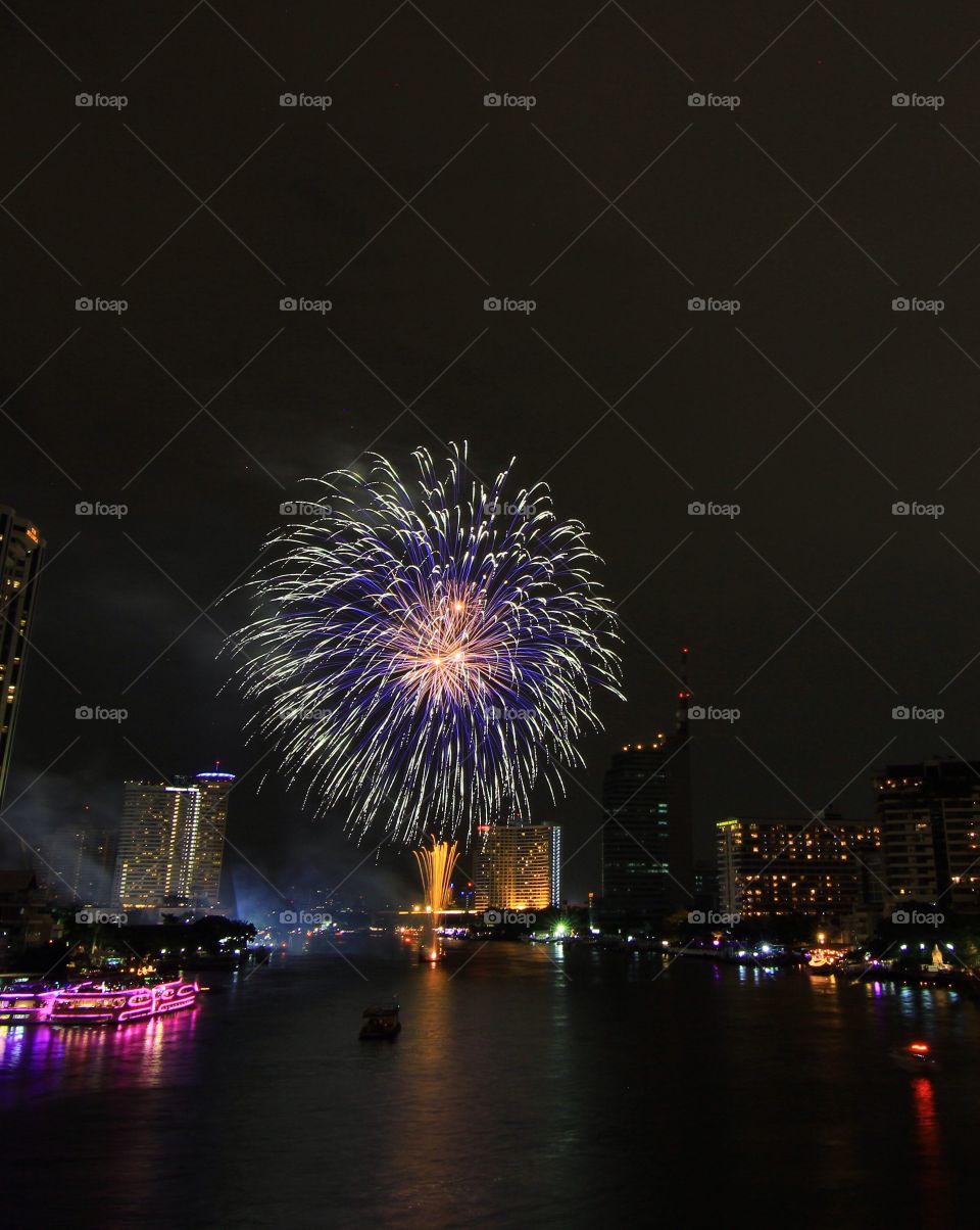 Firework display over a city at night