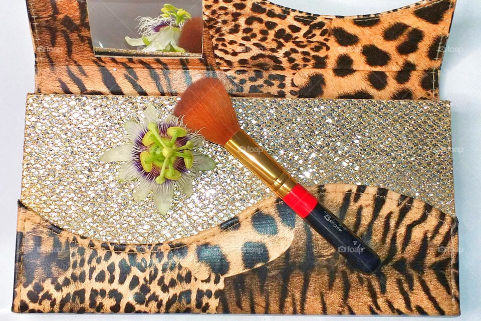 Beauty  products with flowers - Mirror in a purse and a brush