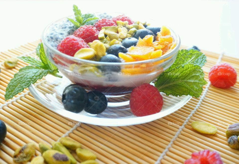 Smoothie Fresh Fruits Bowl - raspberry, blueberry,  mango, nuts and basil seeds