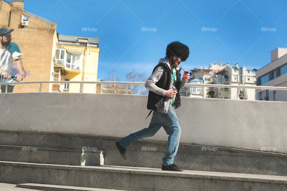 Funny guy with tasty Coca-Cola, walk a little at the street 