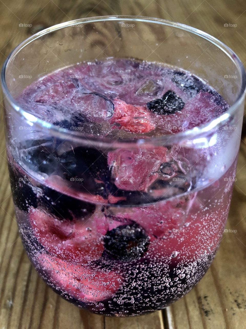 Refreshing raspberries and blueberries drink on hot summer day. 