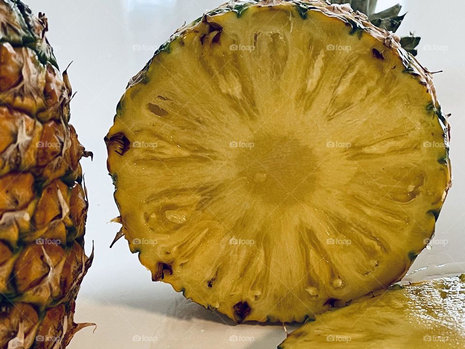 Juicy yellow pineapple slices from above, tropical fruit, Latin American fruit, edible bromeliad 