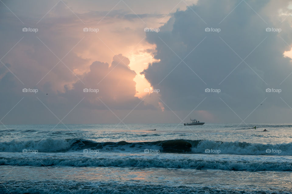 Boat on horizon at dawn