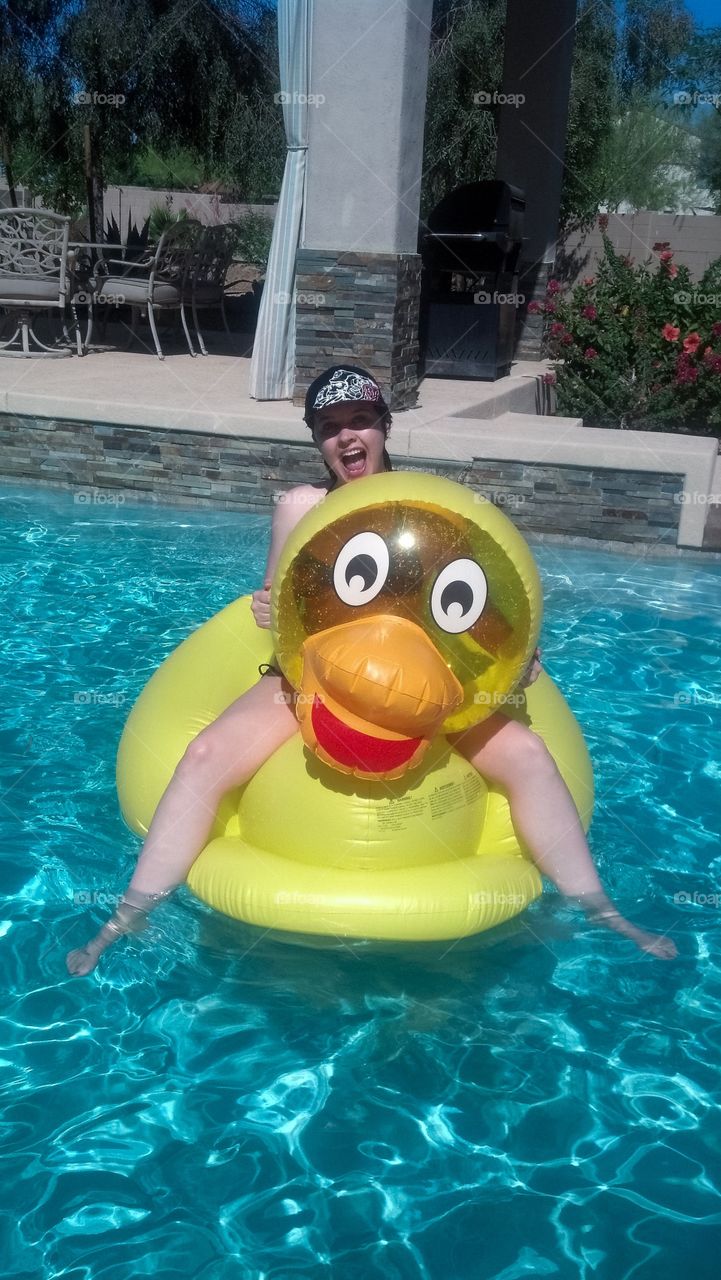 Woman sitting on inflatable ring