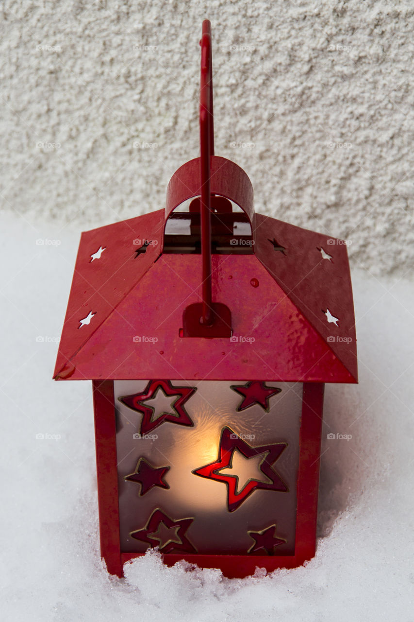 Red lantern with stars - in snow 
