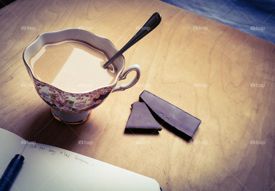 Creamy drink, dark chocolate and my notebook