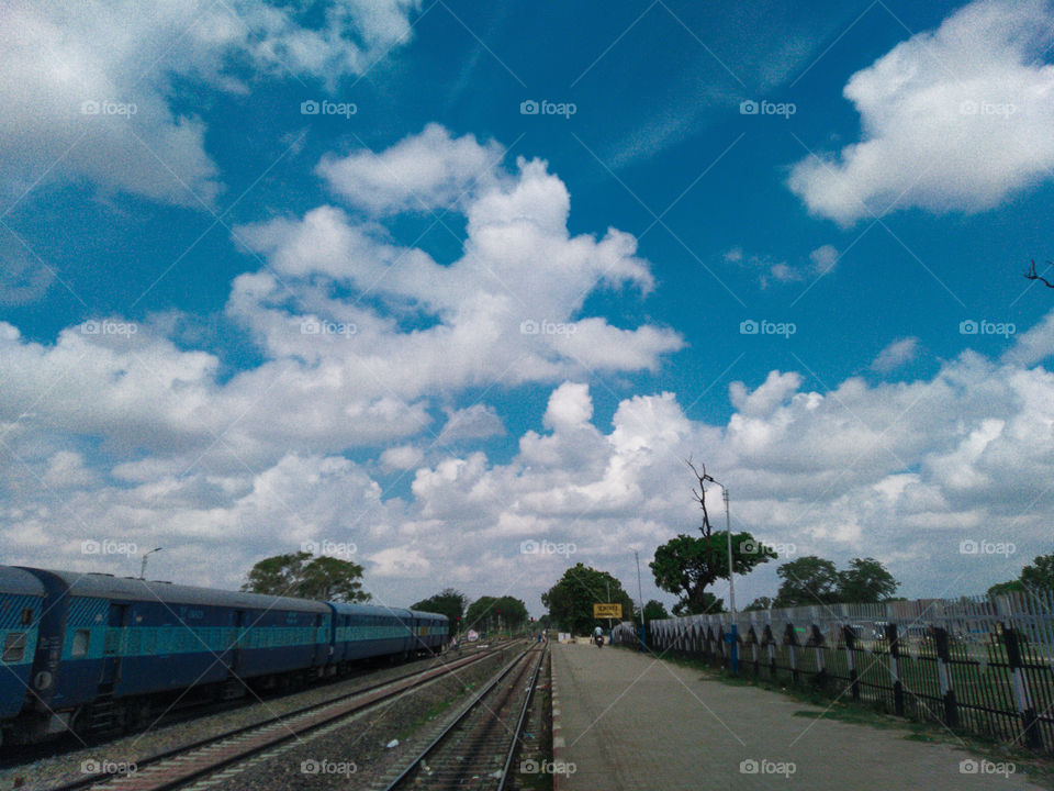 train railway platform blue sky cloud Indian railways