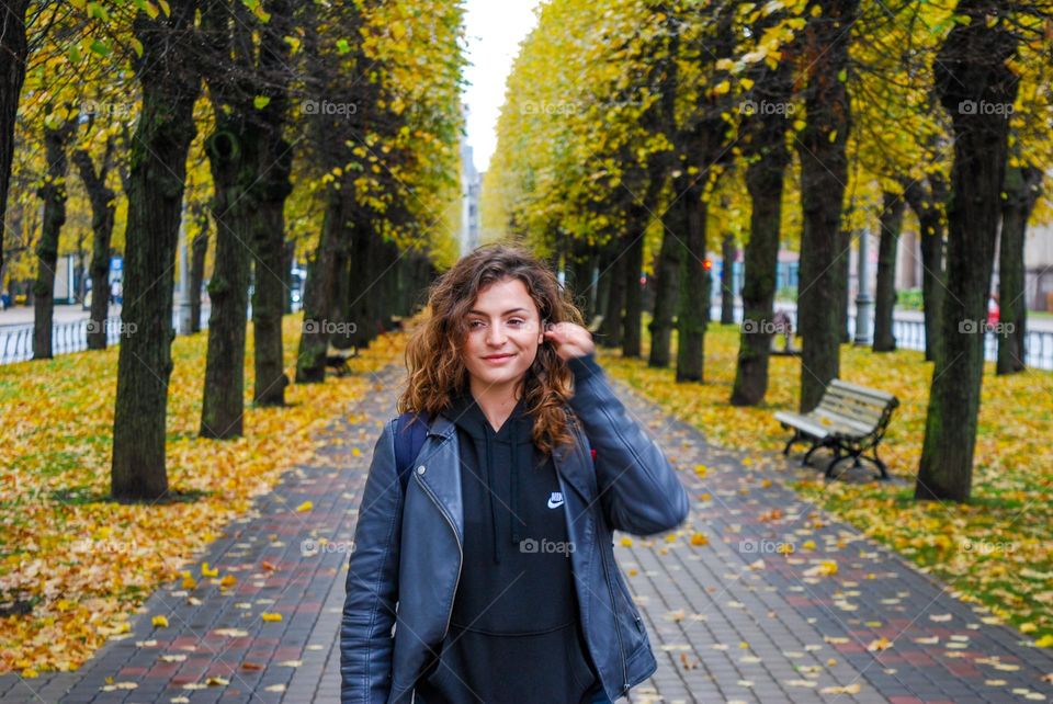 A girl stood on an autumnal path in Riga.