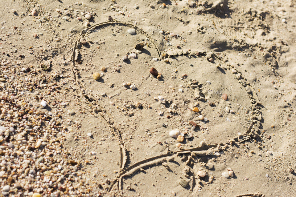 heart in sand. heart drawing in sand on beach