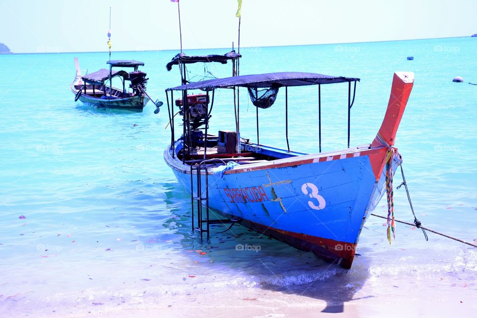 Fishing boat isolated with the blue sea.