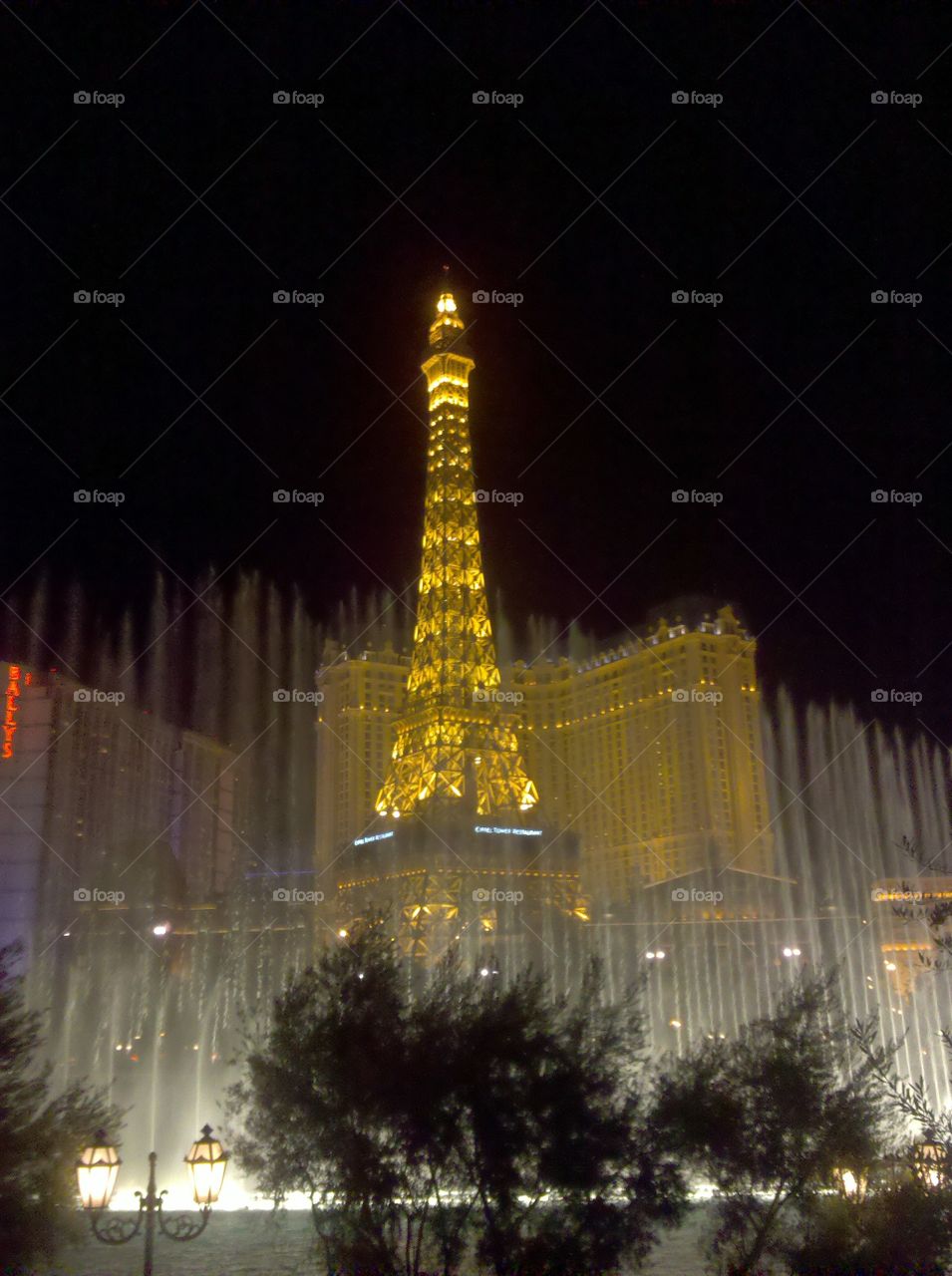 Paris Las Vegas Shot with The Bellagio and Bellagio Fountains at night