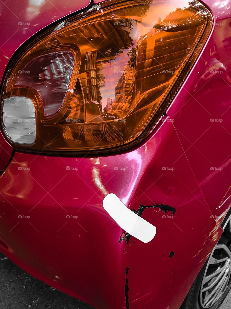 Red car bonnet fized with a bandade.