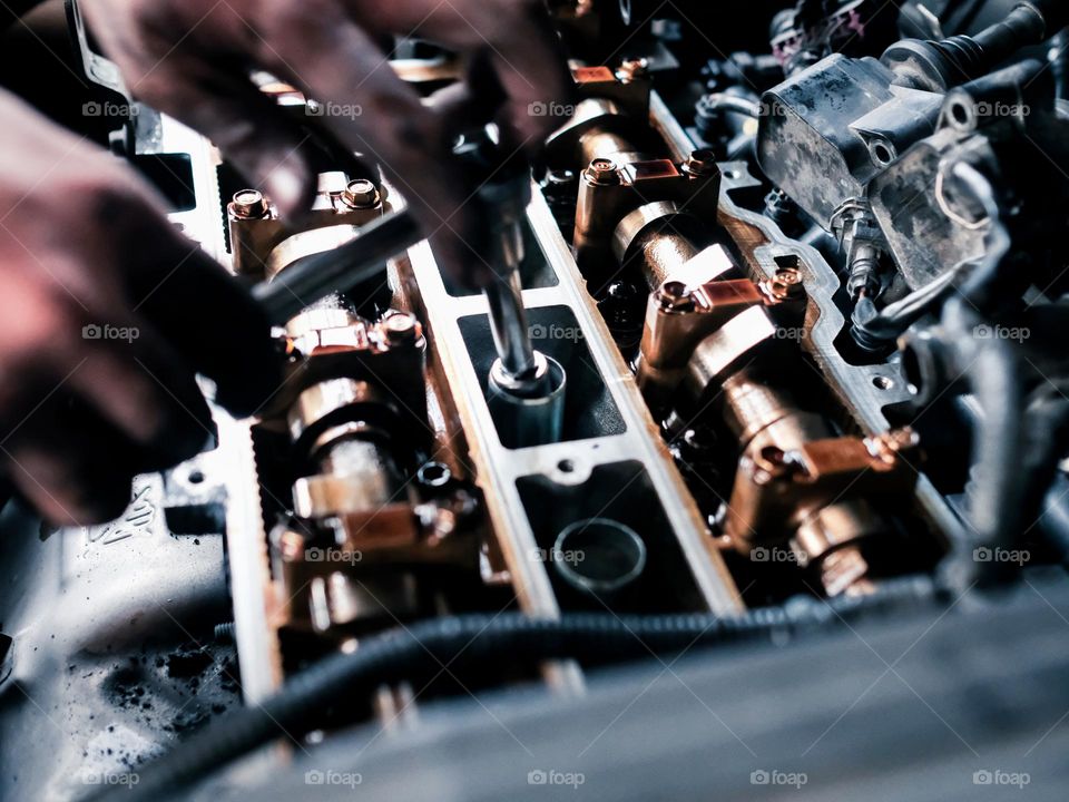 Cropped hand working on the automobile engine top