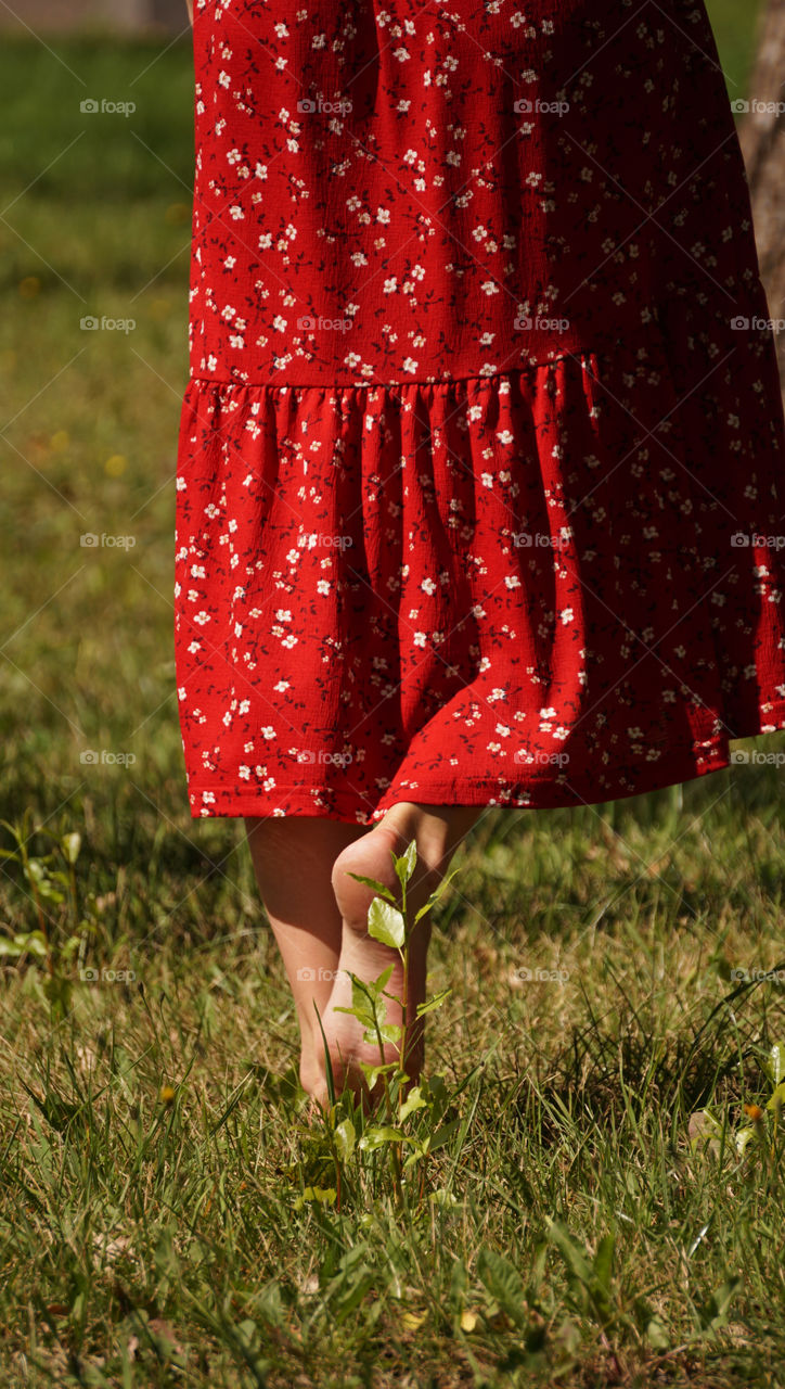 female legs on the grass