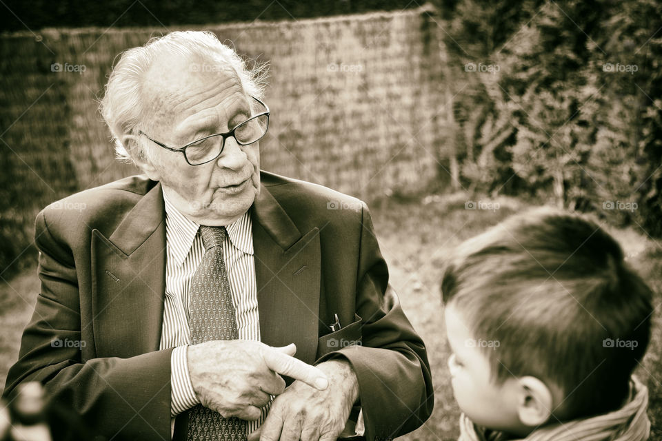 Time flies. Old man with his grand grand son