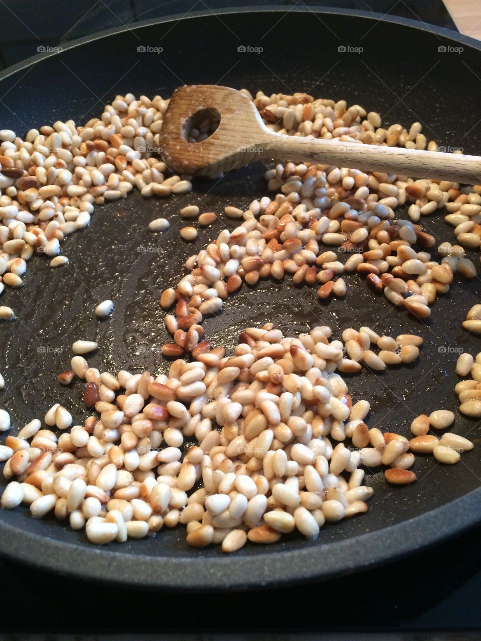 pine nuts in pan, cooking