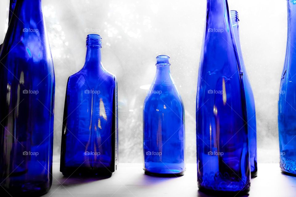 Blue bottles in blurred atmosphere