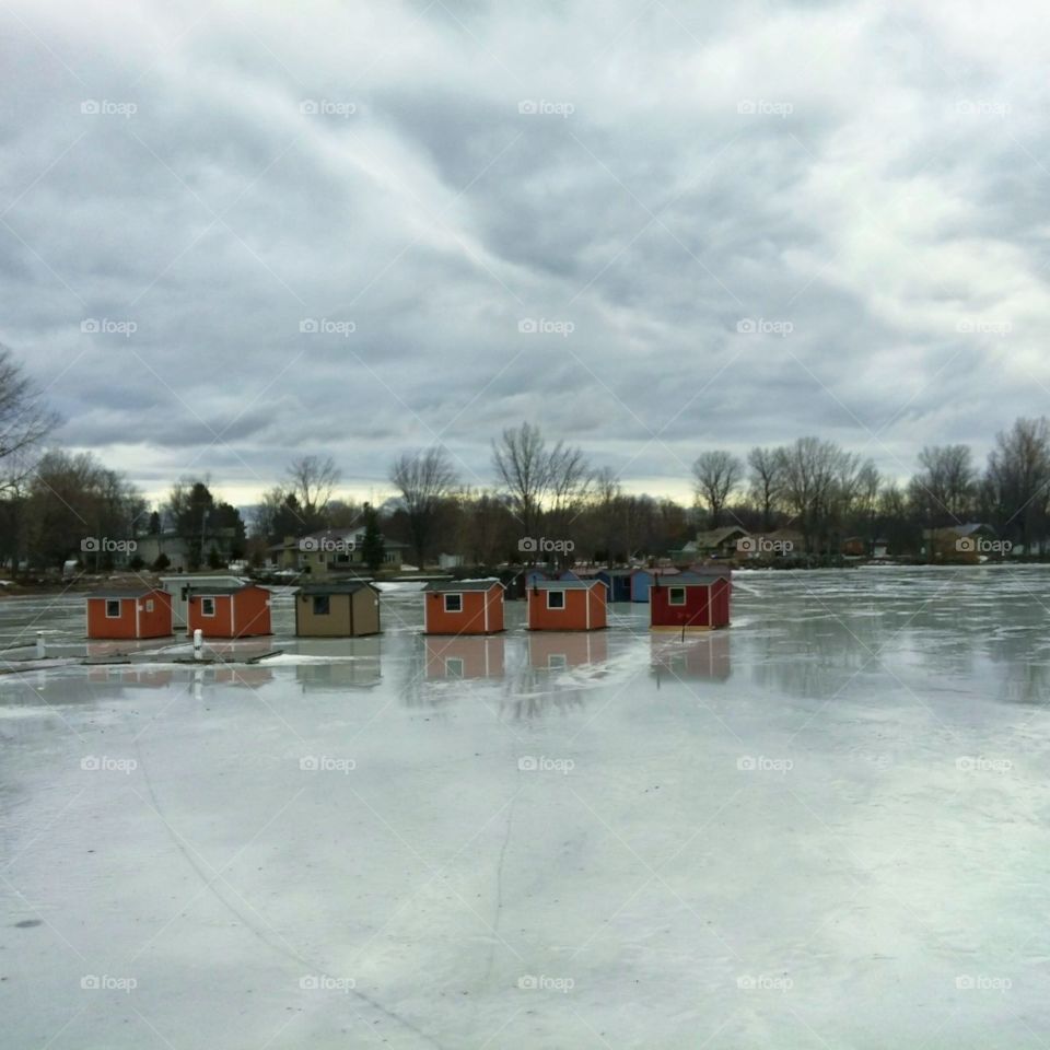 Frozen winter lake with ice huts in QC