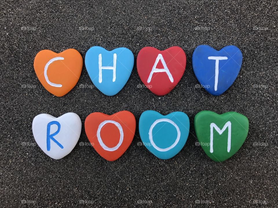 Chat room with colored heart stones over black volcanic sand