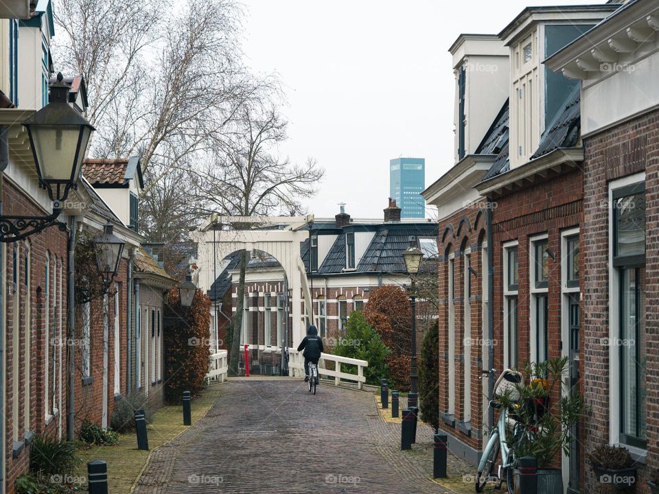 Cozy narrow street in the city, in The Netherlands with a little old bridge