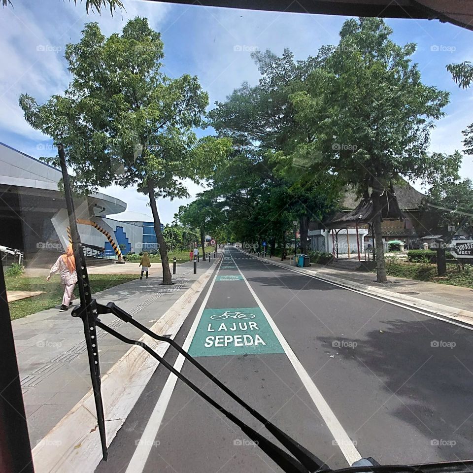 traveling by electric vehicle on empty streets with bicycle lanes on the side