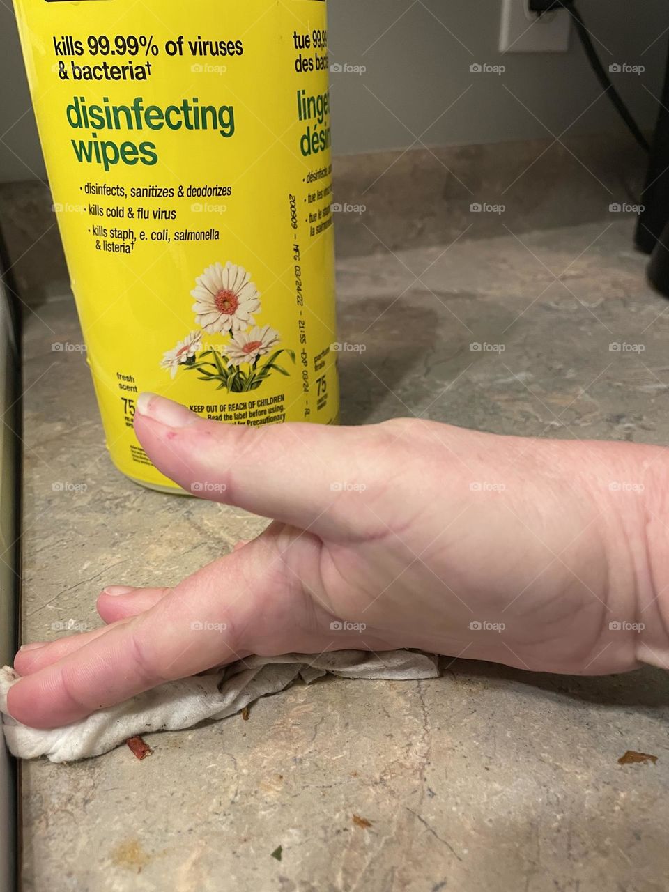 Doing some housework and using my no name disinfecting wipes in a yellow container with green writing, I lifted my thumb up so you can see they work, thats one thing off my list of things to do today