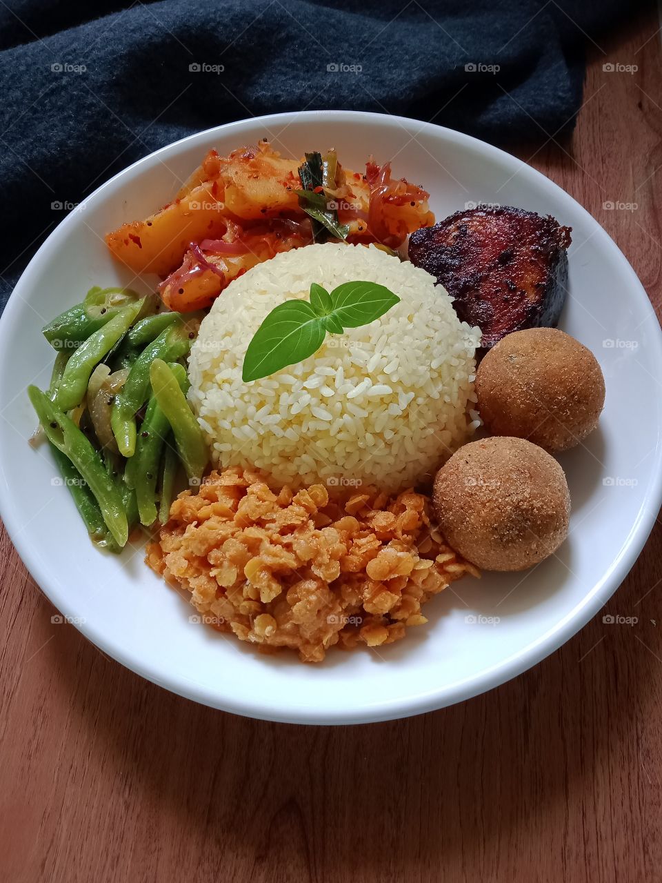 Sri Lankan yellow rice and curry dish .