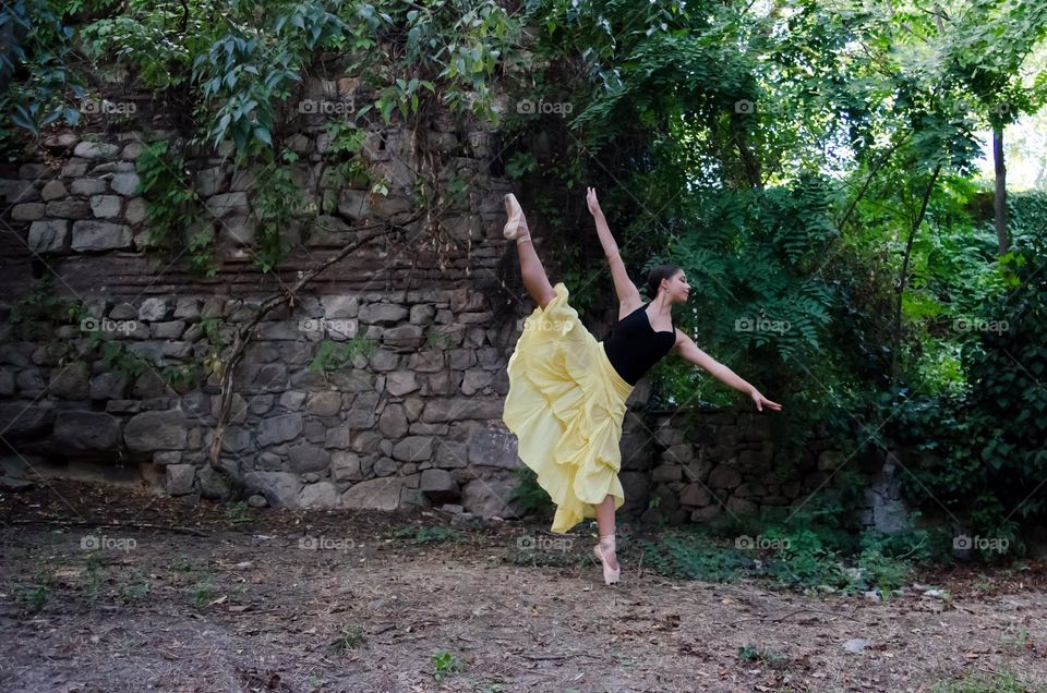 Young Female Ballerina Dancing Outside in Nature