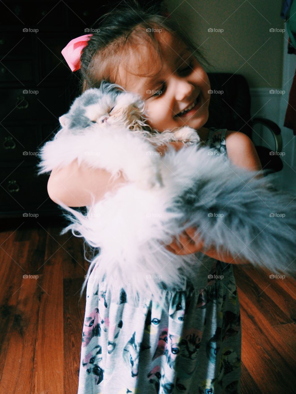 Portrait of a smiling girl with cat