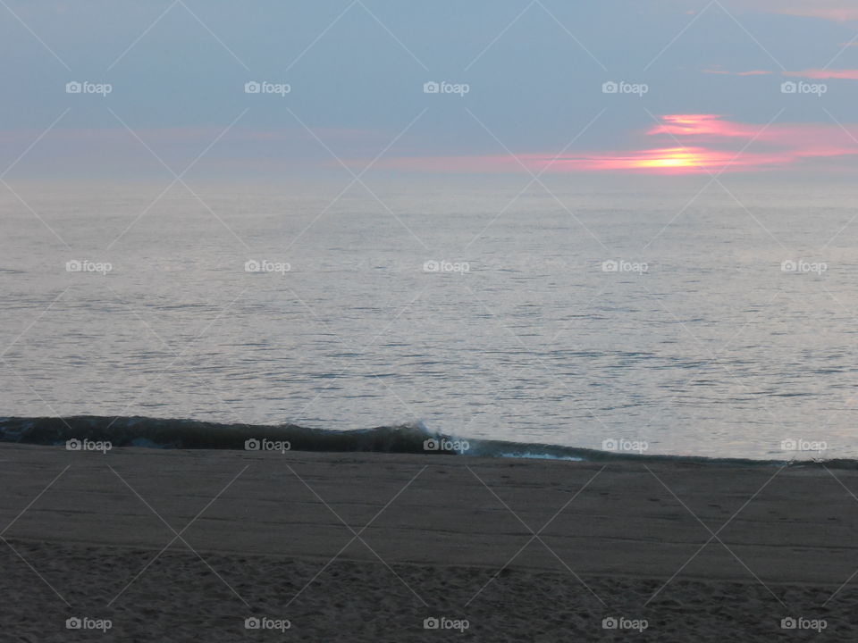 Sun peaking out over Dewey beach Delaware ocean