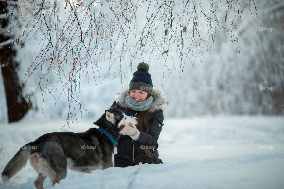 Walking with husky in winter park