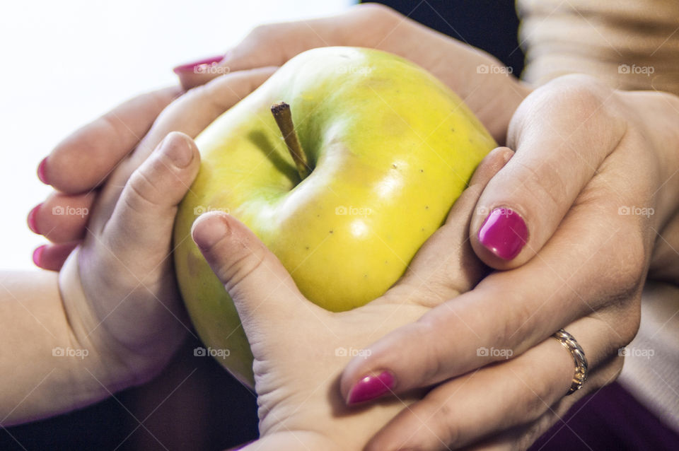 Mother with a small child holding an apple