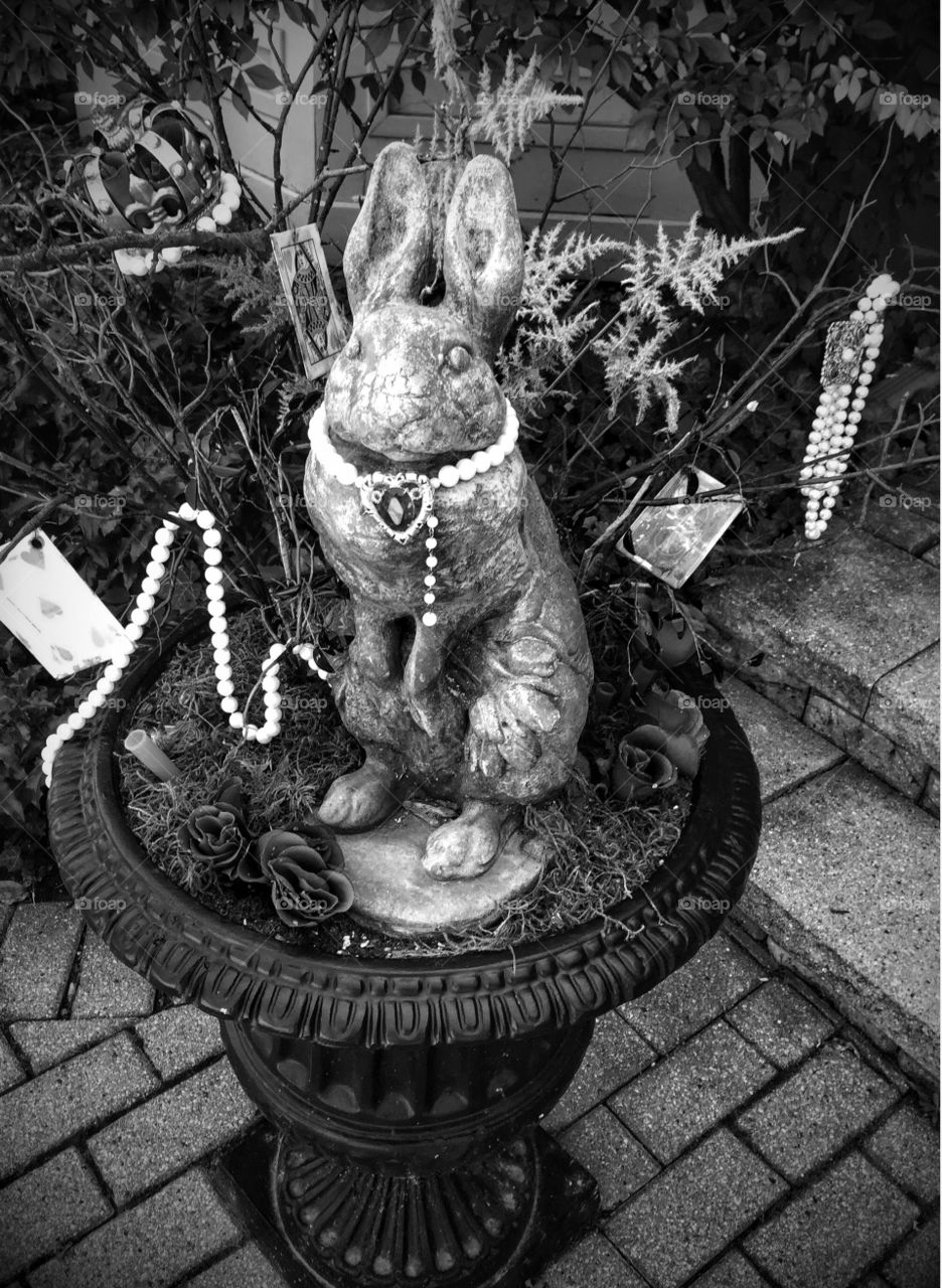 Whimsical black and white. A whimsical rabbit garden planter with strings of beads and jewels