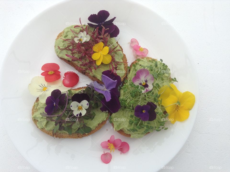 Avocado toast with edible flowers.