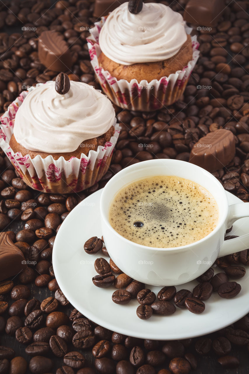 Cupcakes with coffee on coffee beans