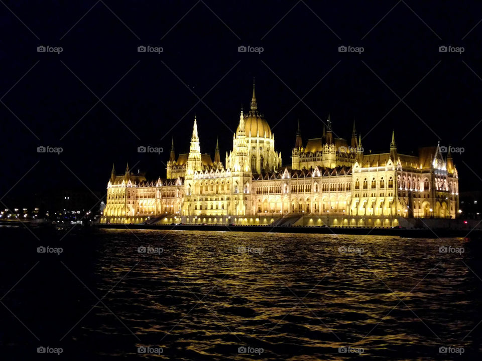 Hungarian parliament building in Budapest, lit up with bright light during the night