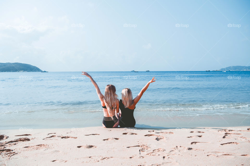 Two blond hair girl on the beach