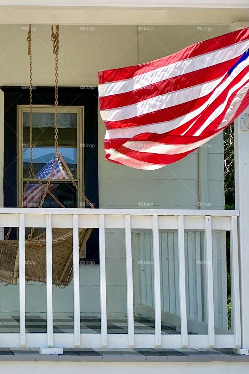 Flag reflecting in widow