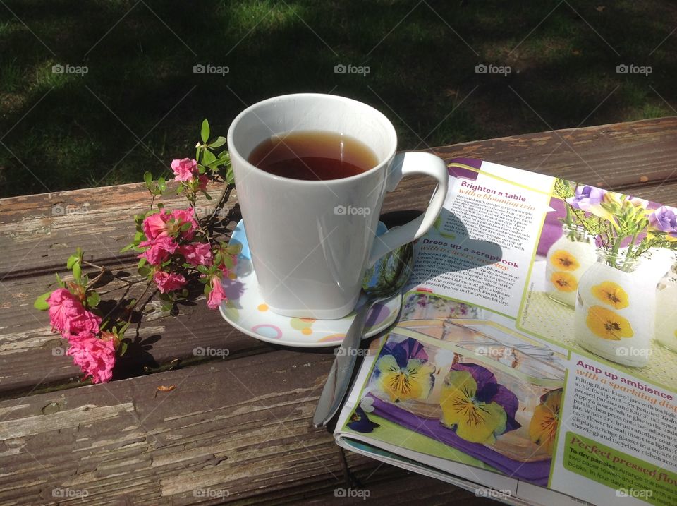 Enjoying a cup of coffee on a beautiful spring day outdoors.