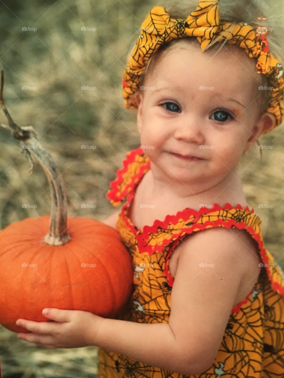 Baby in a pumpkin patch 