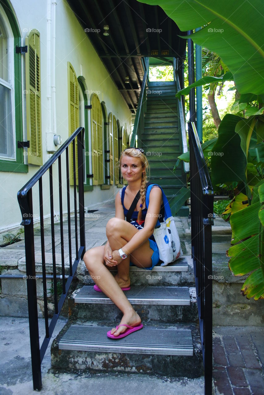 Girl on the stairs at Hemingway's house in Key West, Fl