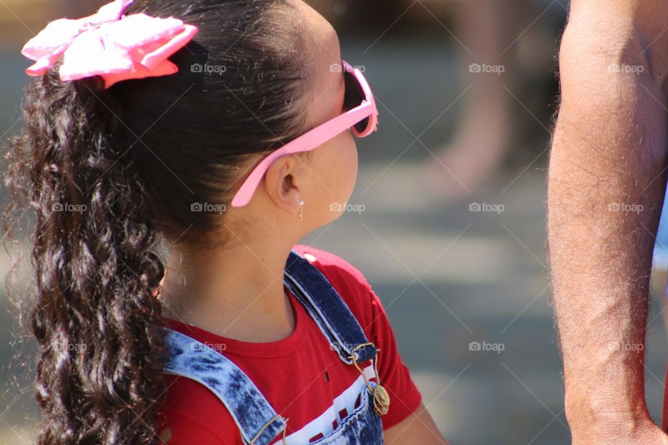 Little girl wearing glasses looking up