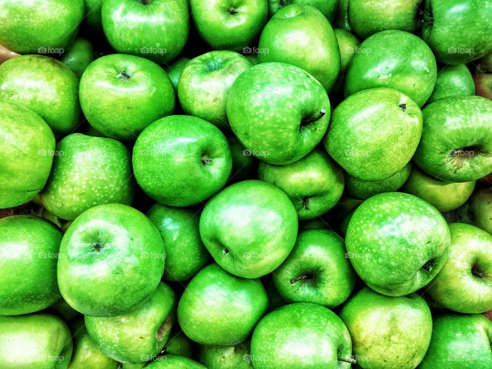 As green as it can be! A pile of green apples for the fruit lover sold at the local farmers market