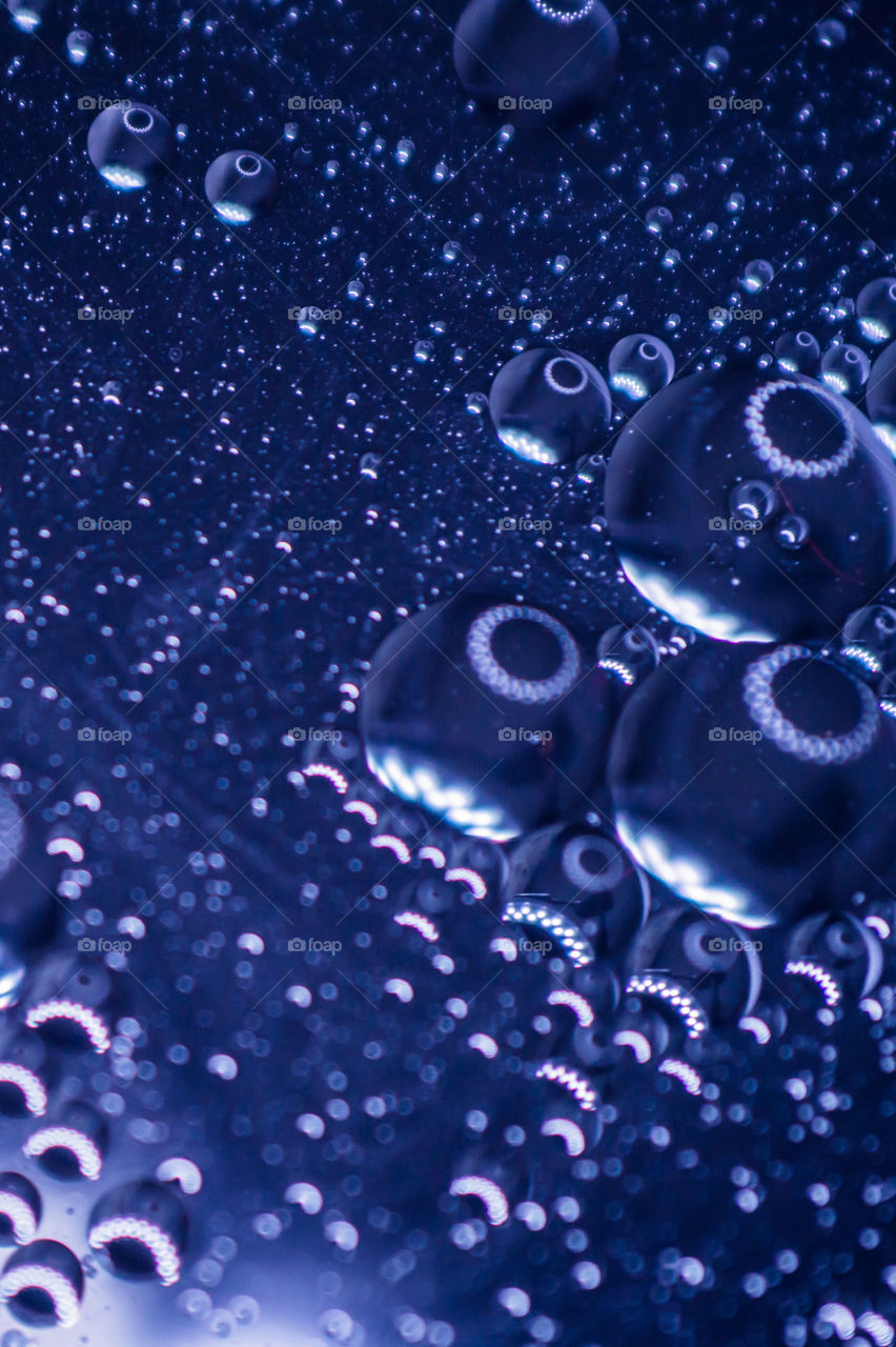 Small bubbles of vegetable oil in water close-up.