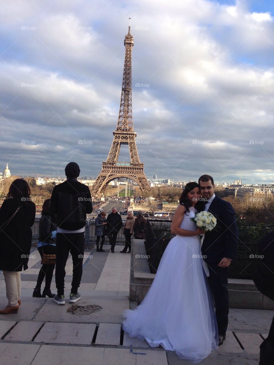 Married couple in front of the Eiffel Tower in Paris 