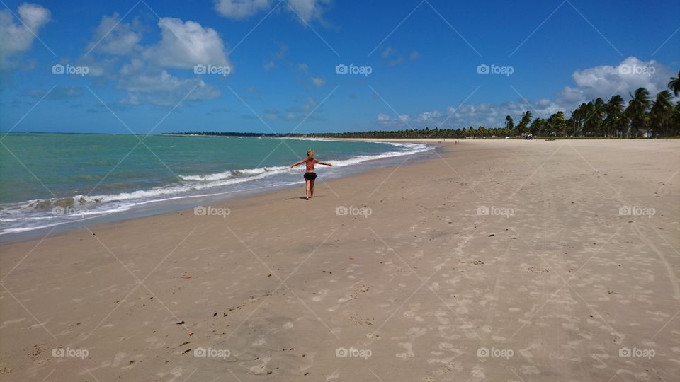 Woman walking in the beach 