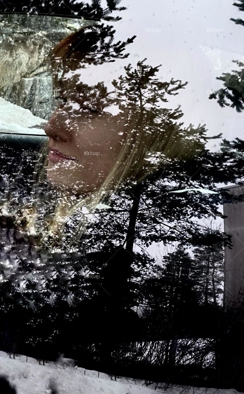 The reflection of the trees in the car window connects to my daughter's profile picture.