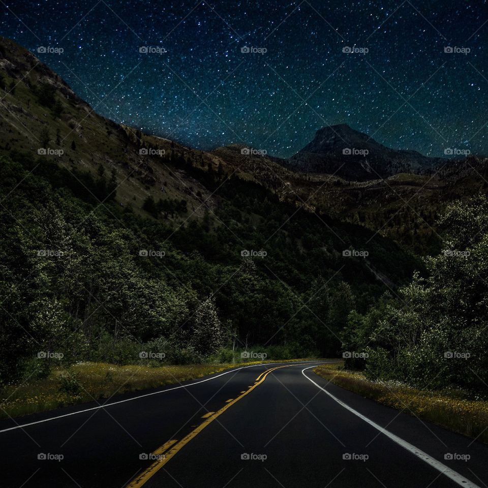 Mountain road in forest at night