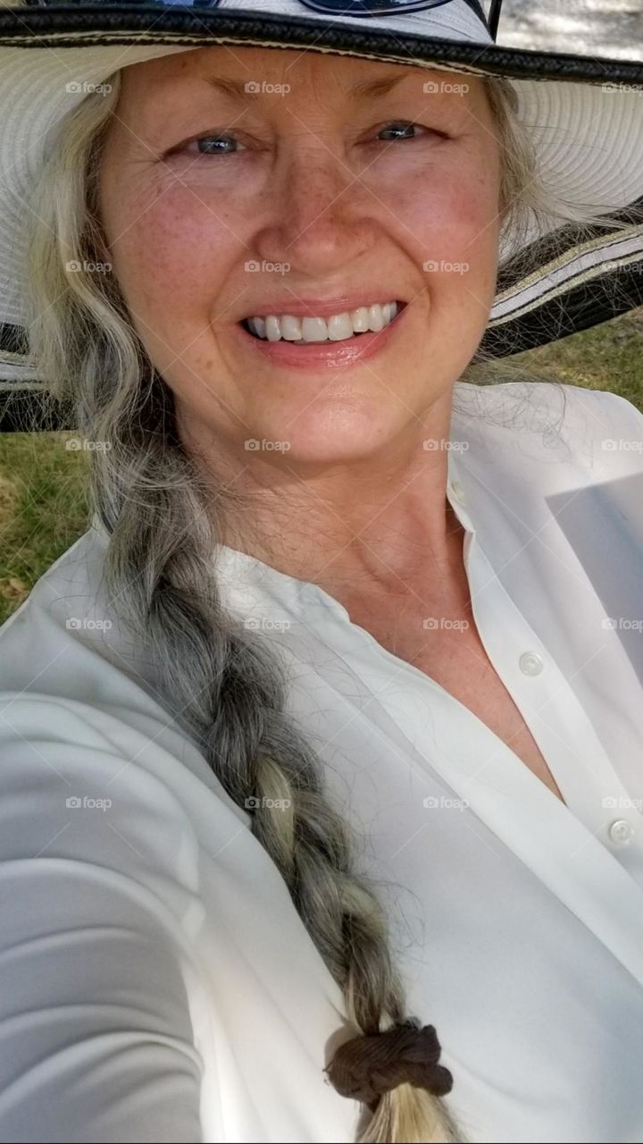 Woman with Braided Salt & Pepper Hair smiling